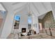 Bright living room featuring high ceilings, a cozy fireplace, and an open floor plan leading to the dining area at 2160 Pueblo Cir, Las Vegas, NV 89169