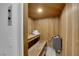 Relaxing sauna featuring wood paneling, built-in benches, and modern heater at 2160 Pueblo Cir, Las Vegas, NV 89169