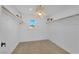 Clean, white walk-in closet with hardwood floors, wood shelving and a sunny window at 2160 Pueblo Cir, Las Vegas, NV 89169