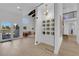 Wine cellar featuring a glass door, modern lighting, and views of the living area with high ceilings at 2160 Pueblo Cir, Las Vegas, NV 89169