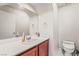 Powder room with cherry-stained cabinets, white countertop, and toilet at 2291 Grannis Ln, Las Vegas, NV 89104