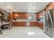 Modern kitchen featuring custom cabinets, stainless steel appliances, and tile flooring at 2291 Grannis Ln, Las Vegas, NV 89104