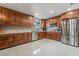 Modern kitchen featuring custom cabinets, stainless steel appliances, and tile flooring at 2291 Grannis Ln, Las Vegas, NV 89104