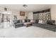 Stylish living room with a large sectional sofa, tile floors, and a view to the dining area at 2291 Grannis Ln, Las Vegas, NV 89104