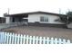 Modest single-story home with gravel landscaping and a white picket fence at 2313 E Mcwilliams Ave, Las Vegas, NV 89101