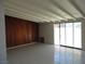 Bright living room featuring tile floors, wood paneling, and access to backyard at 2313 E Mcwilliams Ave, Las Vegas, NV 89101