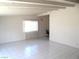 Bright living room with tiled floor, large window and white ceiling beams at 2313 E Mcwilliams Ave, Las Vegas, NV 89101