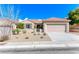 Charming single-story home featuring desert landscaping, a tile roof, and an attached two-car garage at 2702 Grand Forks Rd, Henderson, NV 89052