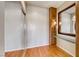 Hallway with wood flooring, built in shelving, mirrored closet, and decorative sconces at 2702 Grand Forks Rd, Henderson, NV 89052