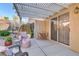 Inviting covered patio with a hanging chair, outdoor seating, and a serene garden view at 2728 Goldcreek St, Henderson, NV 89052