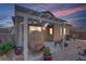 Charming covered patio featuring string lights, cozy seating, and well-maintained landscaping at 2728 Goldcreek St, Henderson, NV 89052