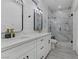 Sleek bathroom featuring double sinks, marble accents, glass shower, and modern fixtures at 2728 Goldcreek St, Henderson, NV 89052