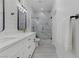 Elegant bathroom with marble accents, glass enclosed shower, and modern double sink vanity at 2728 Goldcreek St, Henderson, NV 89052