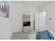 A simple bedroom with white walls, patterned rug, and a TV on a chest for cozy entertainment at 2728 Goldcreek St, Henderson, NV 89052