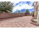 Expansive backyard featuring paver stones, brick walls, a fountain, and well-maintained landscaping at 3009 Little Crimson Ave, North Las Vegas, NV 89081