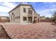 Wide shot of the backyard with desert landscaping, custom paving, and a view of the home's exterior at 3009 Little Crimson Ave, North Las Vegas, NV 89081