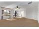 Large primary bedroom featuring neutral carpet, ceiling fan, and natural light from windows and glass door at 3009 Little Crimson Ave, North Las Vegas, NV 89081