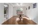 Dining room boasts wood floors, tray ceilings, modern light fixture, and plenty of natural light at 3009 Little Crimson Ave, North Las Vegas, NV 89081