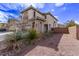 Two-story home featuring a charming stone entryway and lush, desert-friendly landscaping at 3009 Little Crimson Ave, North Las Vegas, NV 89081