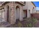 Charming stone-accented entryway with elegant archways and decorative lanterns at 3009 Little Crimson Ave, North Las Vegas, NV 89081