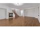 Open-concept living room featuring hardwood floors, fireplace, and stairs at 3009 Little Crimson Ave, North Las Vegas, NV 89081