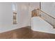 Bright living room features wood floors, staircase with wood banister and abundant natural light from large windows at 3009 Little Crimson Ave, North Las Vegas, NV 89081