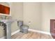 Charming powder room featuring elegant pedestal sink, stylish toilet, and wood-look tile flooring for a sophisticated touch at 32 Hunting Horn Dr, Las Vegas, NV 89135