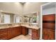 A modern bathroom features dual vanities with wood cabinets and granite countertops at 32 Hunting Horn Dr, Las Vegas, NV 89135