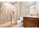 Bathroom showcasing glass shower, granite counters and wood cabinets at 32 Hunting Horn Dr, Las Vegas, NV 89135