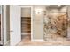 Bathroom with a walk-in shower, custom cabinets and a closet with shelves at 32 Hunting Horn Dr, Las Vegas, NV 89135