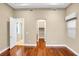 Bedroom with neutral walls and hardwood floors leads to an ensuite and a walk-in closet at 32 Hunting Horn Dr, Las Vegas, NV 89135