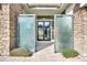 Inviting walkway leads to the front door, framed by modern glass and stone elements at 32 Hunting Horn Dr, Las Vegas, NV 89135