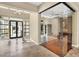 Elegant entryway with tile floors, modern lighting, and a glass enclosed room at 32 Hunting Horn Dr, Las Vegas, NV 89135