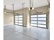 The garage features clear glass panel doors and a gray sealed concrete floor at 32 Hunting Horn Dr, Las Vegas, NV 89135