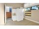 Bright garage with white storage cabinets and outdoor access at 32 Hunting Horn Dr, Las Vegas, NV 89135