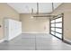 An organized garage with white cabinets and a glass panel door at 32 Hunting Horn Dr, Las Vegas, NV 89135