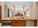 Kitchen island with unique granite countertop, stainless steel sink, and wood cabinets at 32 Hunting Horn Dr, Las Vegas, NV 89135