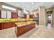 Gourmet kitchen featuring custom wood cabinetry, marble countertops, stainless steel appliances, and designer lighting at 32 Hunting Horn Dr, Las Vegas, NV 89135