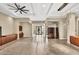 Bright and airy living room with tile flooring, a modern ceiling fan, and ample space at 32 Hunting Horn Dr, Las Vegas, NV 89135