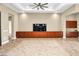 Bright living room with recessed lighting, ceiling fan, and custom entertainment center at 32 Hunting Horn Dr, Las Vegas, NV 89135