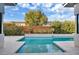 Stunning backyard pool surrounded by modern landscaping and privacy fencing at 32 Hunting Horn Dr, Las Vegas, NV 89135