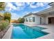 Backyard pool with blue skies, clean patio, and landscaping at 32 Hunting Horn Dr, Las Vegas, NV 89135