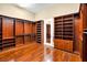 Expansive walk-in closet boasts custom wood shelving, hanging racks, and polished hardwood floors at 32 Hunting Horn Dr, Las Vegas, NV 89135