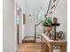 Bright foyer with hardwood floors, staircase and decorative table with fresh flower arrangement near a window at 330 Rancho Cir, Las Vegas, NV 89107