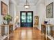 Elegant foyer with hardwood floors, a tray ceiling, and dual entry doors at 330 Rancho Cir, Las Vegas, NV 89107