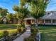 Beautiful traditional home featuring mature trees, a walkway, and manicured landscaping at 330 Rancho Cir, Las Vegas, NV 89107