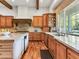 Spacious kitchen with wooden beams, granite countertops, and natural wood cabinetry at 330 Rancho Cir, Las Vegas, NV 89107