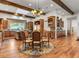 Open-concept kitchen and dining area with hardwood floors, skylights, and custom cabinets at 330 Rancho Cir, Las Vegas, NV 89107