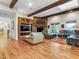 Inviting living room with hardwood floors, wooden beam ceilings, and a stone fireplace at 330 Rancho Cir, Las Vegas, NV 89107