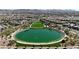 Aerial view of a community park featuring a serene lake, surrounded by lush greenery and walking paths at 371 Silva Pl, Henderson, NV 89011